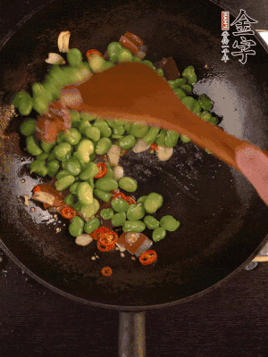 再下蠶豆煸炒，加1勺料酒調(diào)味。
